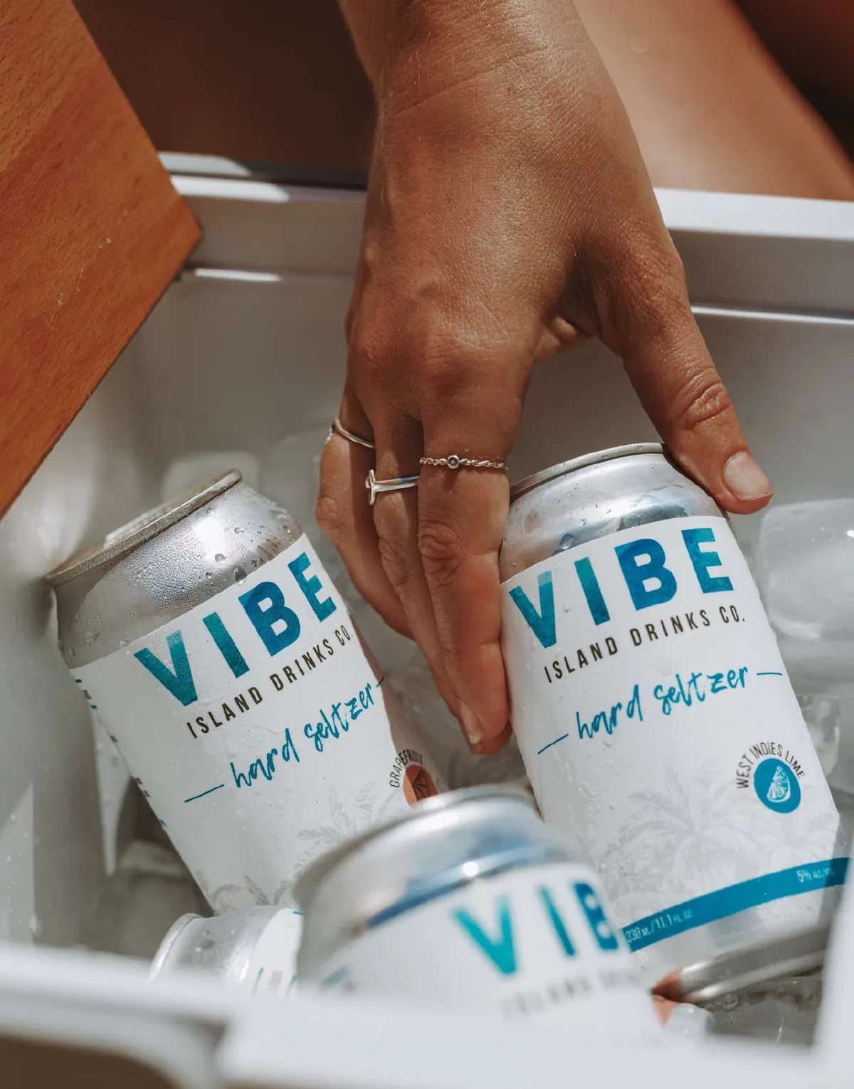 Cans of Vibe Hard Seltzer on ice in a cooler